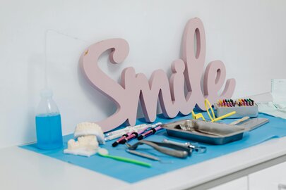 Smiling person at dentist and selecting eyeglasses